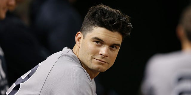 Andrew Benintendi of the New York Yankees looks on from the dugout during the game against the Oakland Athletics at RingCentral Coliseum in Oakland, California, on Aug. 26, 2022.