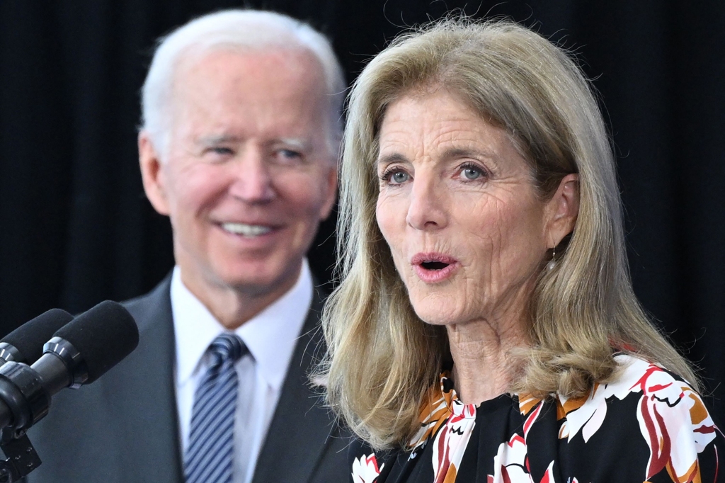 US President Joe Biden (L) looks on as US Ambassador to Australia Caroline Kennedy delivers remarks at the John F. Kennedy Library and Museum in Boston, Massachussetts.
