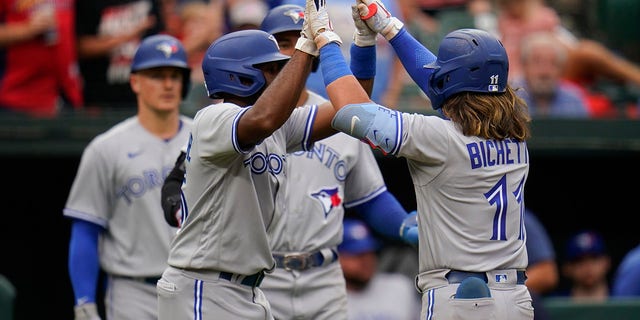 Toronto Blue Jays' Bo Bichette, right, celebrates with Jackie Bradley Jr., left, after Bichette hit a three-run home run off Baltimore Orioles relief pitcher Nick Vespi during the third inning of the second game of a baseball doubleheader, Monday, Sept. 5, 2022, in Baltimore. Bradley Jr. and teammate George Springer scored on the home run.