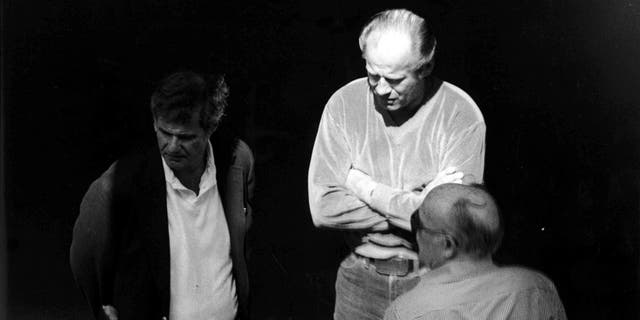 This 1980 surveillance photo released by the U.S. Attorney's Office and presented as evidence during the first day of a trial for James "Whitey" Bulger in U.S. District Court in Boston, June 12, 2013, shows Bulger, center, with Ted Berenson, left, and Phil Wagenheim at a Lancaster Street garage in Boston's North End.