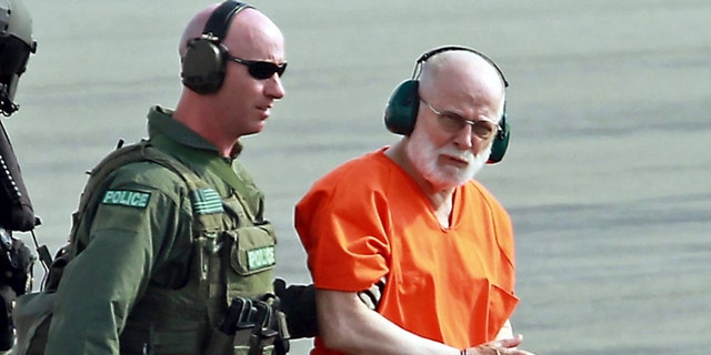 In this June 30, 2011, file photo, James "Whitey" Bulger, right, is escorted from a U.S. Coast Guard helicopter to a waiting vehicle at an airport in Plymouth, Massachusetts, after attending hearings in federal court in Boston.