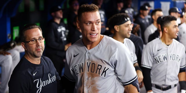 Aaron Judge, #99 of the New York Yankees, is congratulated by teammates after hitting his 61st home run of the season in the seventh inning against the Toronto Blue Jays at Rogers Centre on Sept. 28, 2022 in Toronto. Judge has now tied Roger Maris for the American League record.