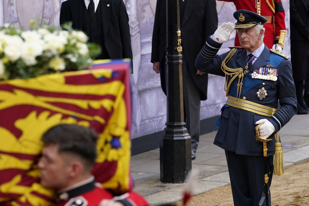 King Charles III salutes his mother's grave. 