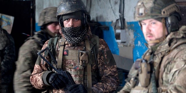 Servicemen of the Ukrainian Military Forces wait out the shelling in a shelter on a position in the Luhansk region on March 5, 2022. 