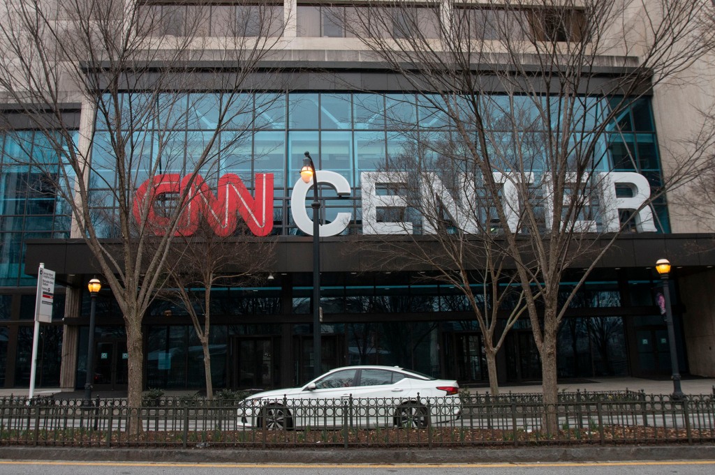 A CNN logo is displayed over the entrance to the CNN Center in Atlanta 