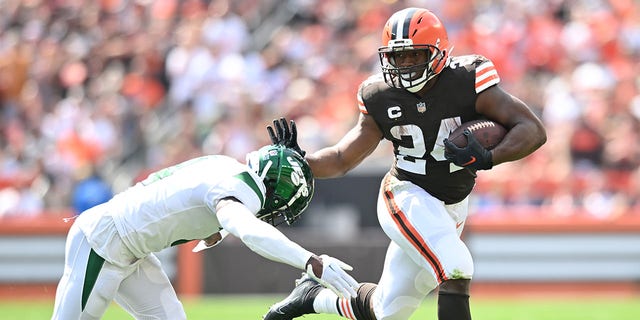 Nick Chubb (24) of the Cleveland Browns runs with the ball before being tackled by D.J. Reed of the New York Jets during the first quarter at FirstEnergy Stadium on Sept. 18, 2022, in Cleveland.