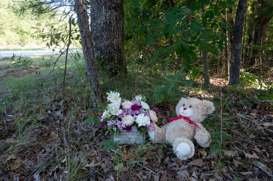 Teddy bear and flowers left near the murder scene.