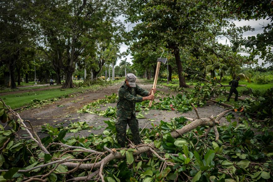 A soldier clearing debris from the street in Havana.