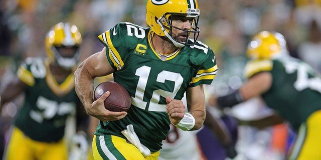 Aaron Rodgers, #12 of the Green Bay Packers, runs for yards during a game against the Chicago Bears at Lambeau Field on Sept. 18, 2022 in Green Bay, Wisconsin.