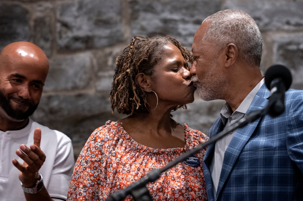 Don Samuels kisses his wife, Sondra Samuels, who was part of the team who successfully sued the city to meet minimum policing levels as mandated by city charter. 