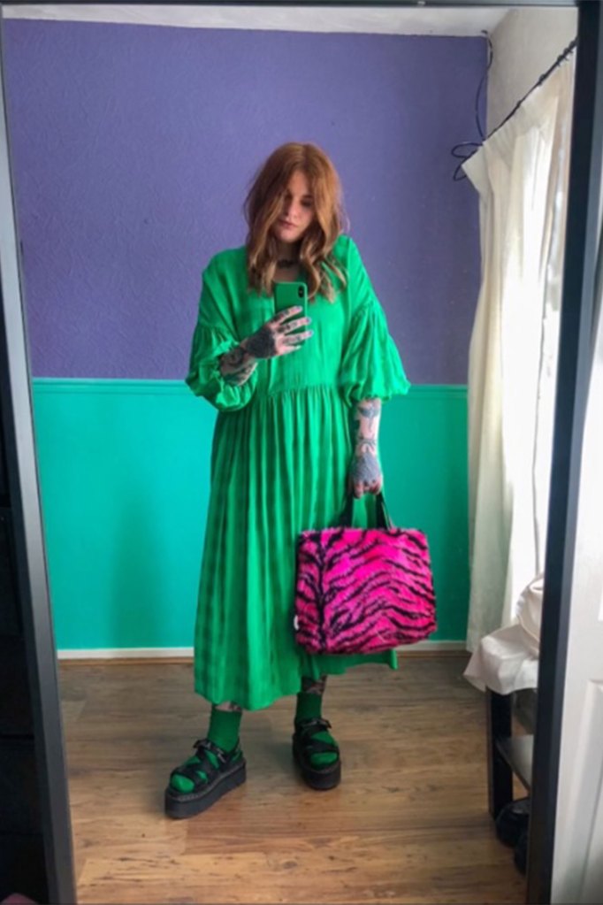 TikToker in green dress holding pink bag