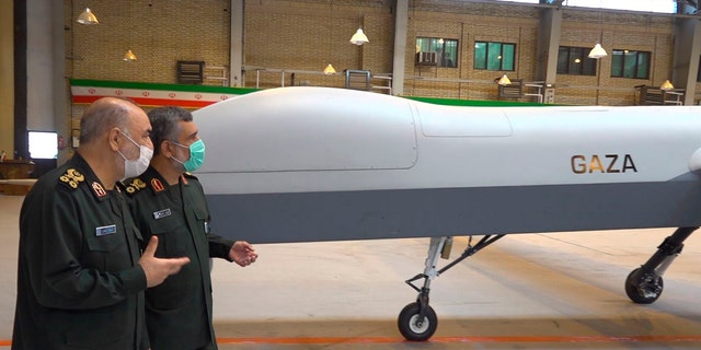 In this photo released on Saturday, May 22, 2021, by Sepahnews of the Iranian Revolutionary Guard, the Guard's Commander Gen. Hossein Salami, left, and the Guard's aerospace division commander Gen. Amir Ali Hajizadeh talk while unveiling a new drone called "Gaza" in an undisclosed location in Iran. 