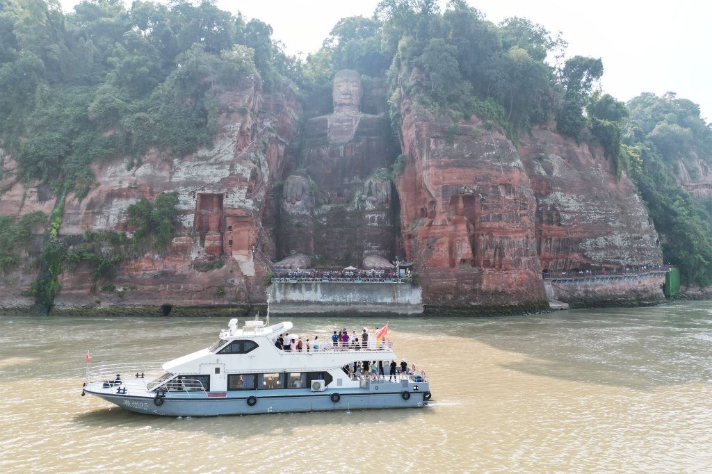 Tourists take a boat to view the Leshan giant Buddha on August 20 in China.