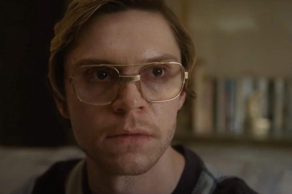 A close up of Evan Peters face in glasses. 