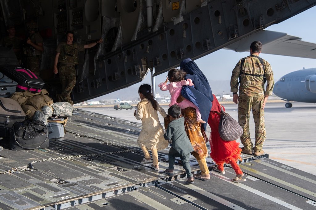 A US Air Force plane loads passengers as troops race to evacuate as many people as possible. 