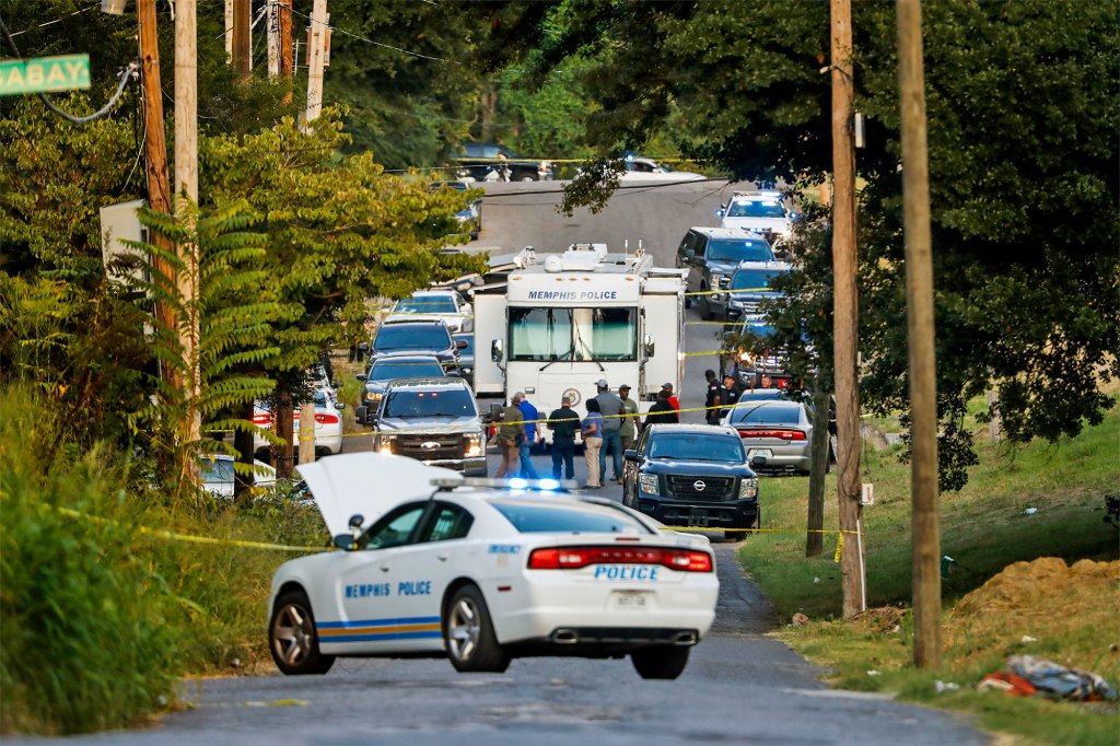 Memphis police officers search an area where a body had been found in South Memphis, 