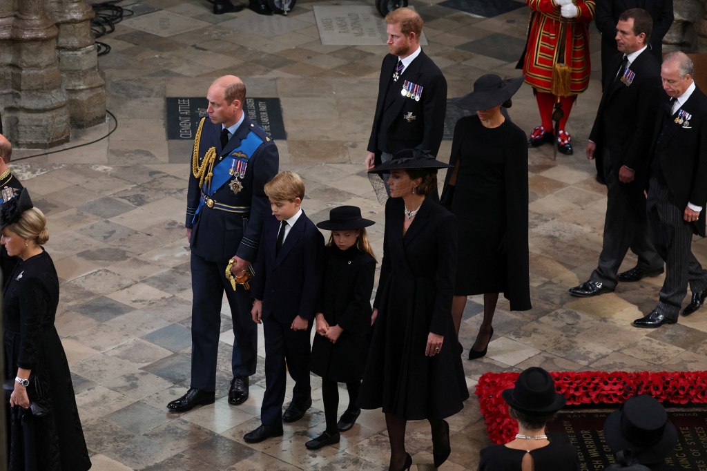 LONDON, ENGLAND - SEPTEMBER 19: Prince William, Prince of Wales, Prince George of Wales, Princess Charlotte of Wales, Catherine, Princess of Wales, Prince Harry, Duke of Sussex and Meghan, Duchess of Sussex follow the coffin of Queen Elizabeth II during the State Funeral of Queen Elizabeth II at Westminster Abbey on September 19, 2022 in London, England.  Elizabeth Alexandra Mary Windsor was born in Bruton Street, Mayfair, London on 21 April 1926. She married Prince Philip in 1947 and ascended the throne of the United Kingdom and Commonwealth on 6 February 1952 after the death of her Father, King George VI. Queen Elizabeth II died at Balmoral Castle in Scotland on September 8, 2022, and is succeeded by her eldest son, King Charles III. (Photo by Phil Noble - WPA Pool/Getty Images)