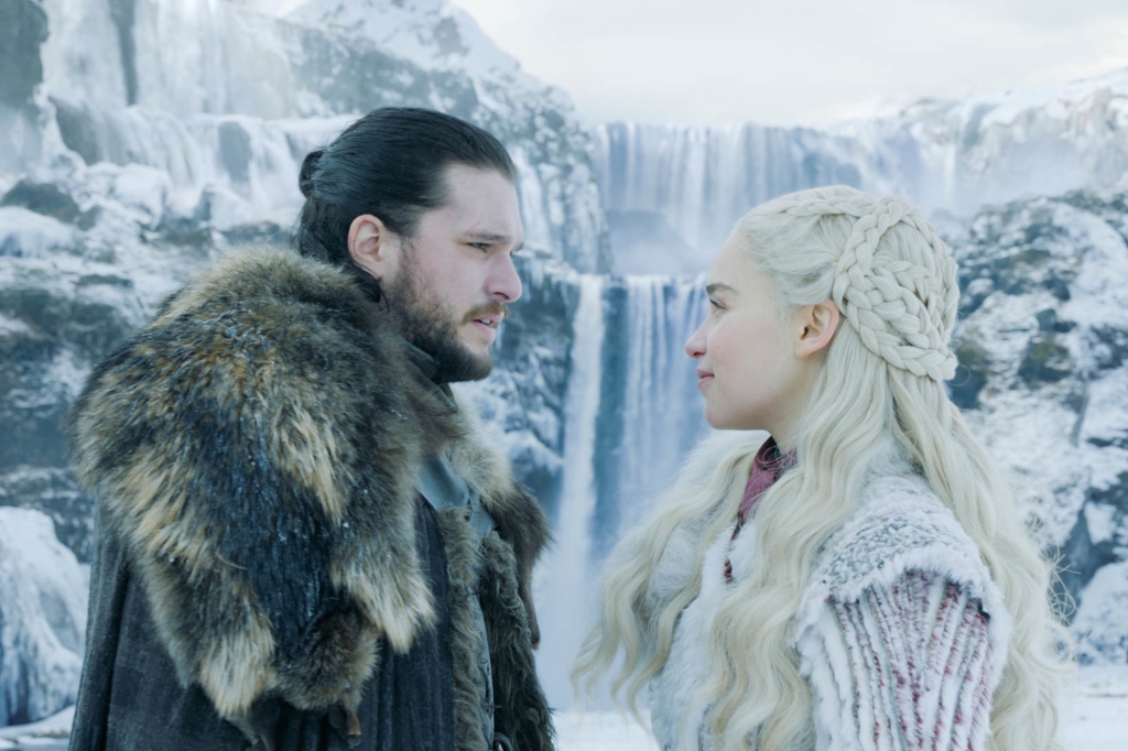 Jon Snow (Kit Harington) and Daenerys (Emilia Clarke) on "Game of Thrones" face each other outside in the snow. 