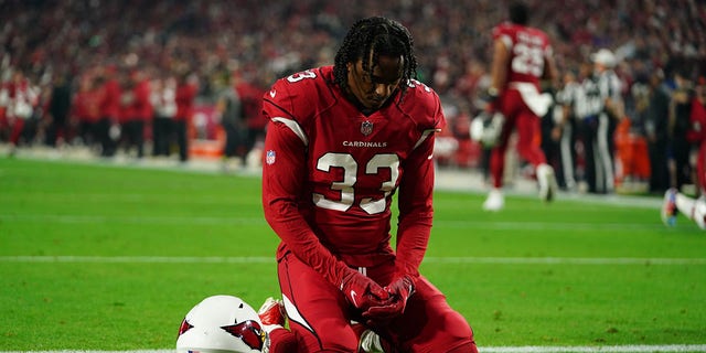 Antonio Hamilton of the Arizona Cardinals kneels in the end zone prior to an NFL game against the Los Angeles Rams at State Farm Stadium in Glendale, Arizona, on Dec. 13, 2021.