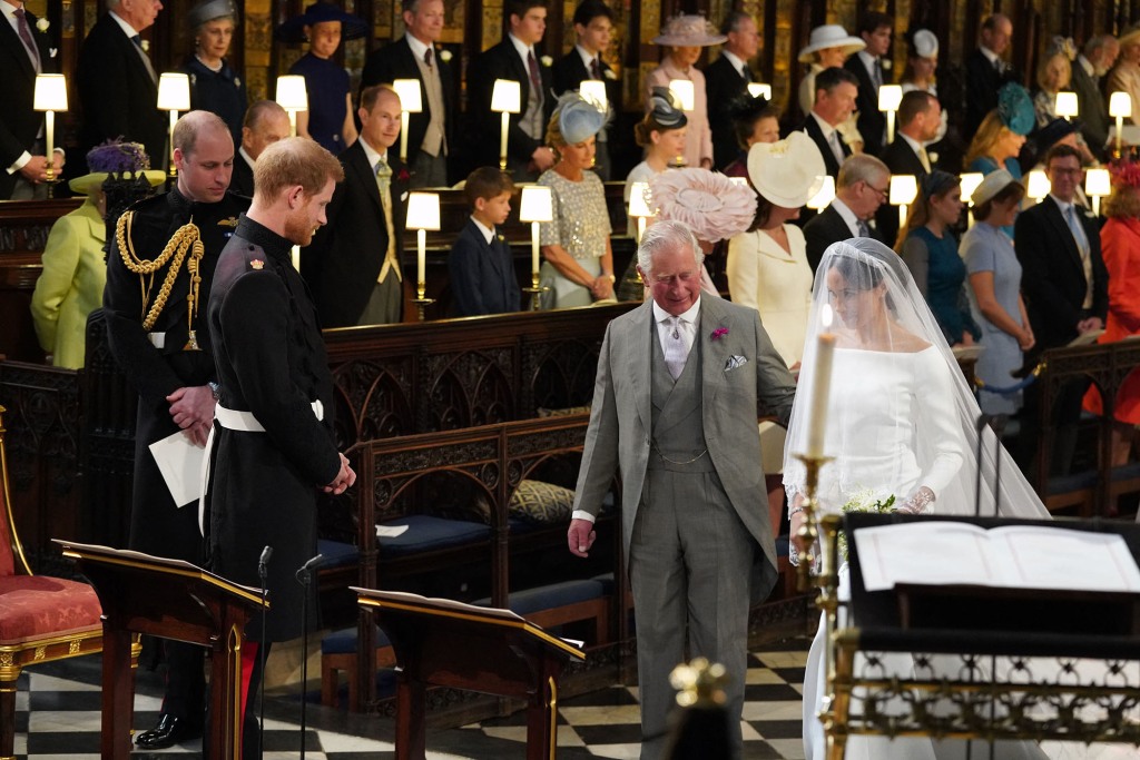 Harry looks on as his father walks Meghan Markle down the aisle for their 2018 royal wedding.