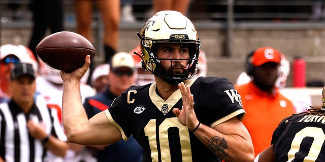 Sam Hartman, #10 of the Wake Forest Demon Deacons, drops back to pass against the Clemson Tigers during the first half of their game at Truist Field on September 24, 2022, in Winston-Salem, North Carolina.