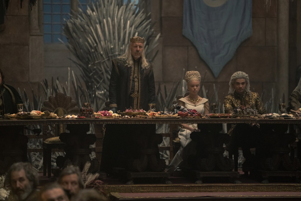 King Viserys (Paddy Consideine), Rhaenyra (Milly Alcock) and Laenor (Theo Nate) at the disaster wedding feast on "House of the Dragon." 