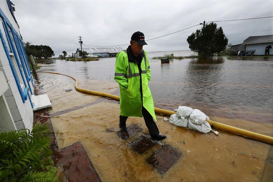 City Manager Robert Horton checks on flooded homes and stores along St. Mary's Street in historic downtown St. Mary's, Ga., while wind and rain from Tropical Storm Ian begin to arrive on Thursday, Sept. 29, 2022. (Curtis Compton/Atlanta Journal-Constitution via AP)