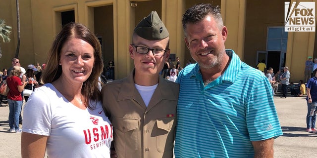 Jared stands with his father, Mark, and his stepmother, Jaclyn.