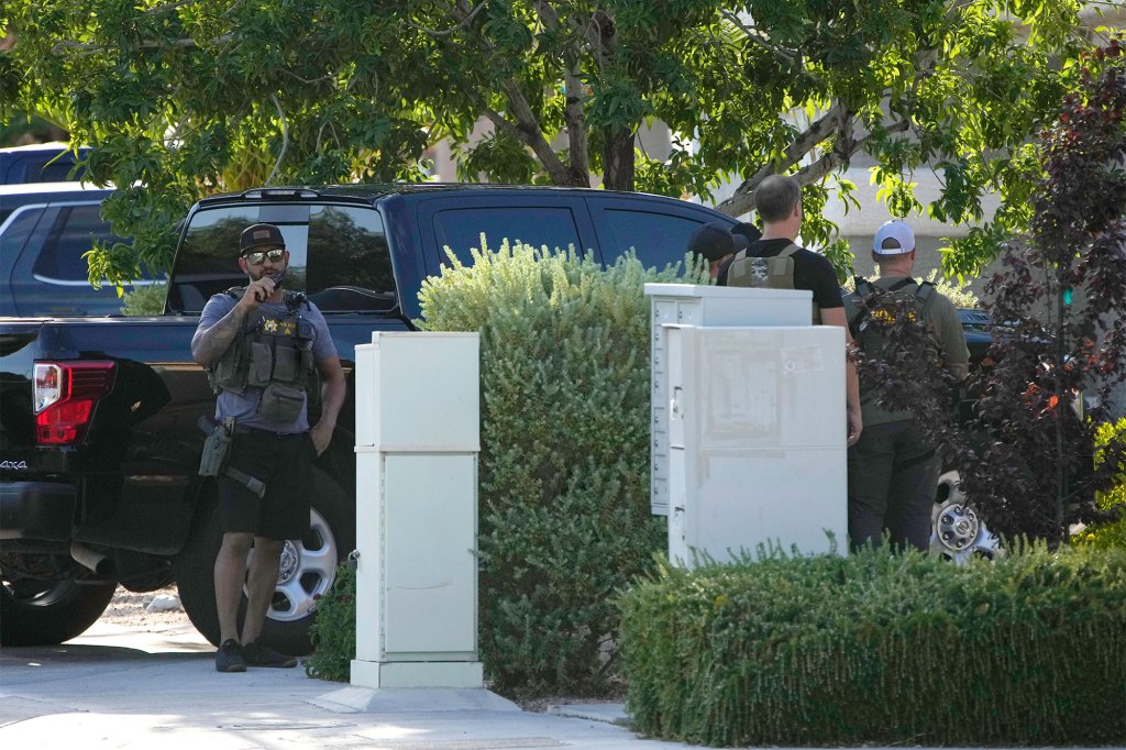 Police take positions around the house of Clark County Public Administrator Robert Telles,