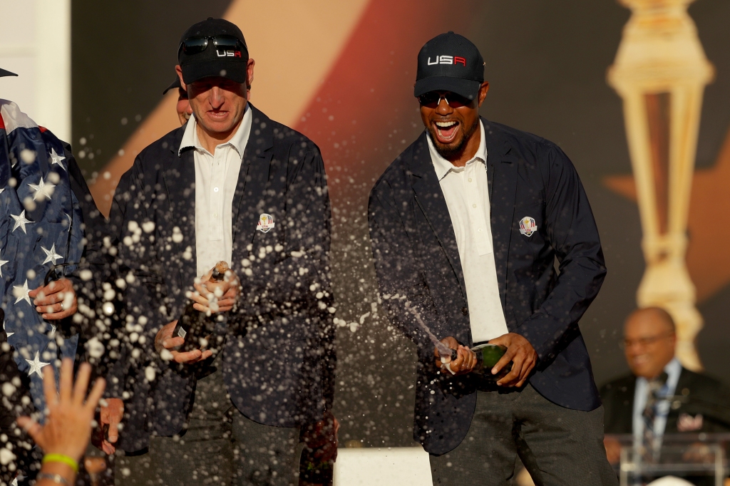 Vice-captains Jim Furyk and vice-captain Tiger Woods celebrate after winning the Ryder Cup in 2016.