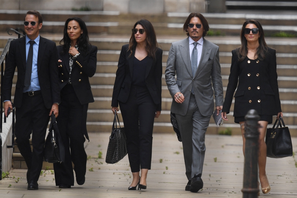 US actor Johnny Depp (2R) leaves with members of his team including lawyer Adam Waldman (L) after day eight of his libel trial against News Group Newspapers (NGN) at the High Court in London, on July 16, 2020.