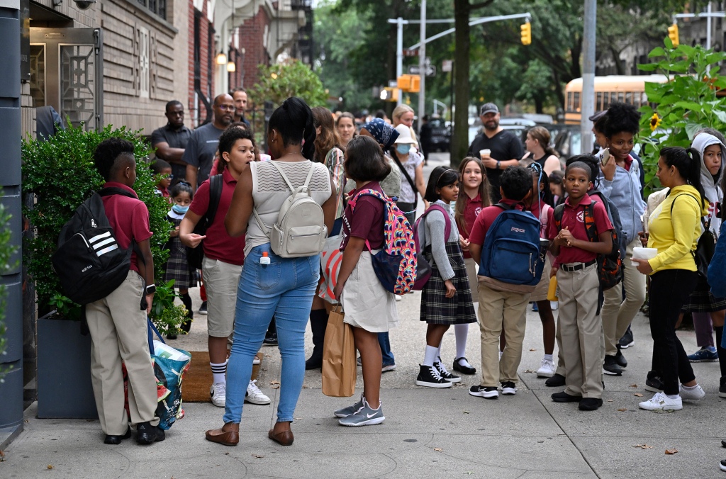 NYC Catholic school kids stand outside in their uniforms