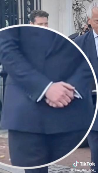 A closeup of a bodyguard's clasped hands.