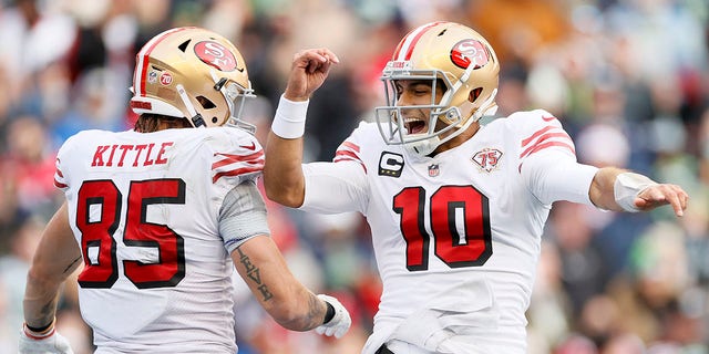 Jimmy Garoppolo (10) of the San Francisco 49ers celebrates after throwing a touchdown pass to George Kittle (85) during the second quarter against the Seattle Seahawks at Lumen Field Dec. 5, 2021 in Seattle.