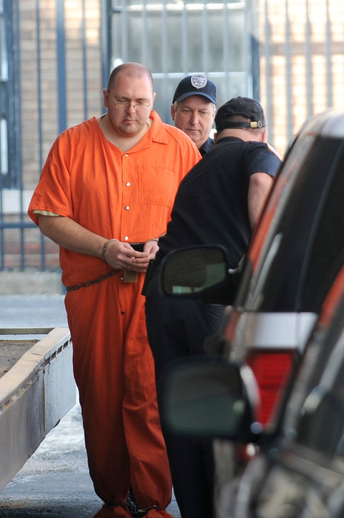Michael Carneal, 27, is escorted by a guard from the U.S. District Courthouse in Paducah, Ky., March 18, 2011. 