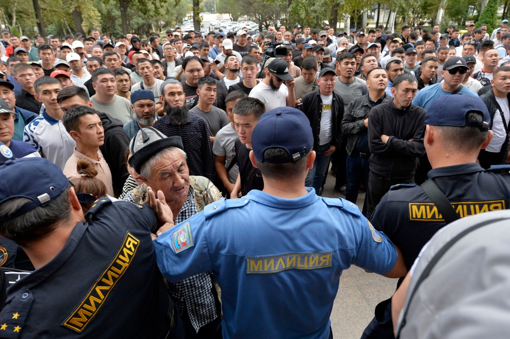 Kyrgyz volunteers gather outside the government building demanding they be sent to the conflict zone at the Kyrgyz-Tajik border, in Bishkek, Kyrgyzstan, Friday, Sept. 16, 2022. 