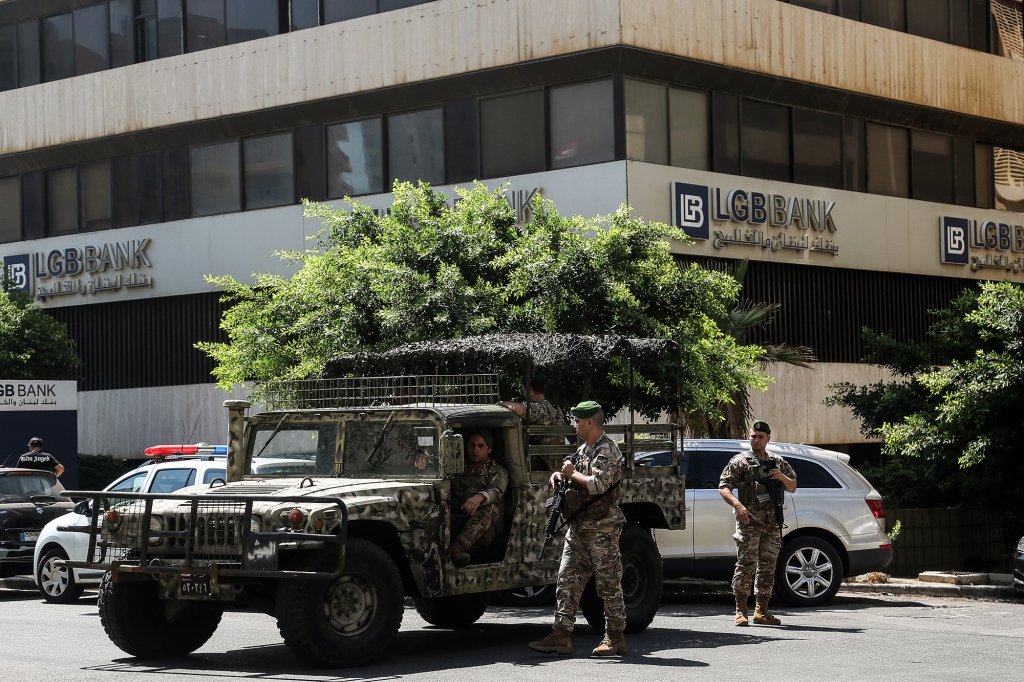 Soldiers and armored vehicles outside a Beirut bank earlier this month after a frustrated depositor stormed the branch and, like Al-Saii, demanded his money. It was one of three such incident in Beirut that week. 