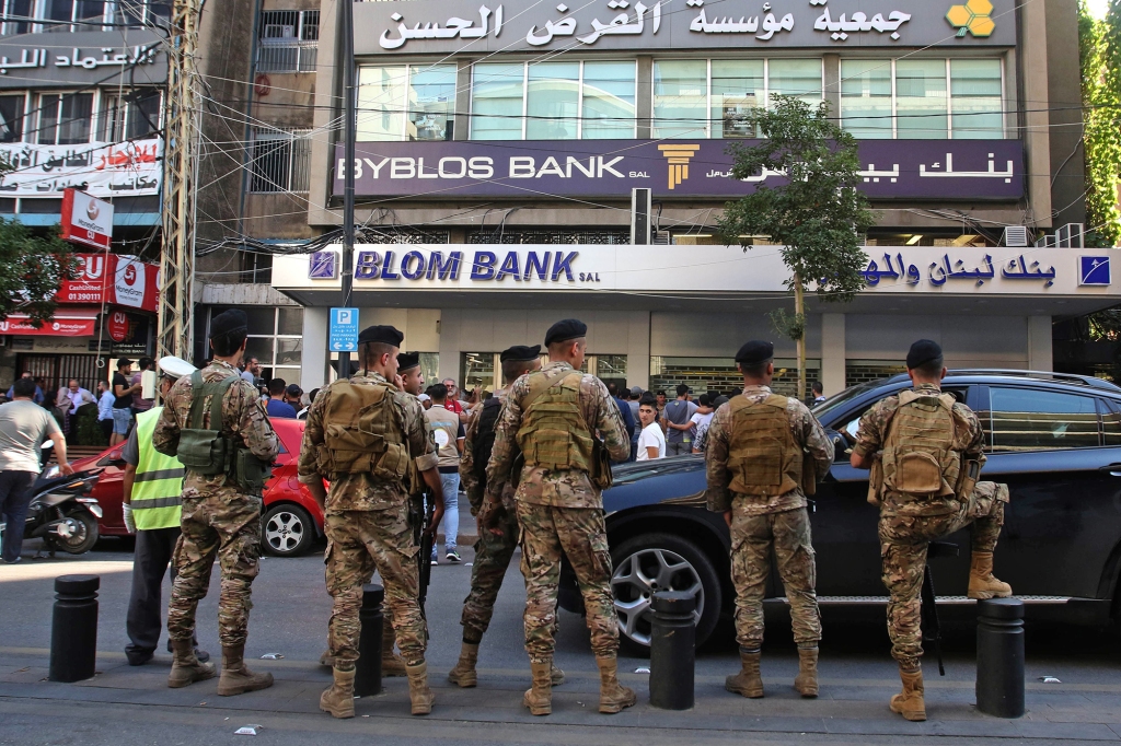 Lebanese soldiers guard a Beirut bank following anti-government protests. Such scenes are becoming increasingly common as everyday Beirutis become fed-up with the nation's economic disaster. 