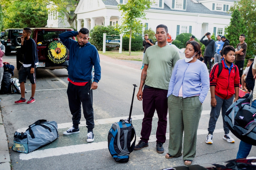 Migrants, who arrived on a flight sent by Florida Gov. Ron DeSantis, gather with their belongings outside St. Andrews Episcopal Church, Wednesday Sept. 14, 2022, in Edgartown, Mass.
