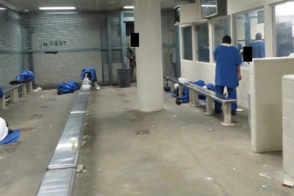 Inmates sleep on the ground alongside garbage within the Lo Angeles prison.
