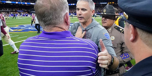 Florida State head coach Mike Norvell, facing, greets LSU head coach Brian Kelly after their NCAA college football game in New Orleans, Sunday, Sept. 4, 2022. Florida State won 24-23.