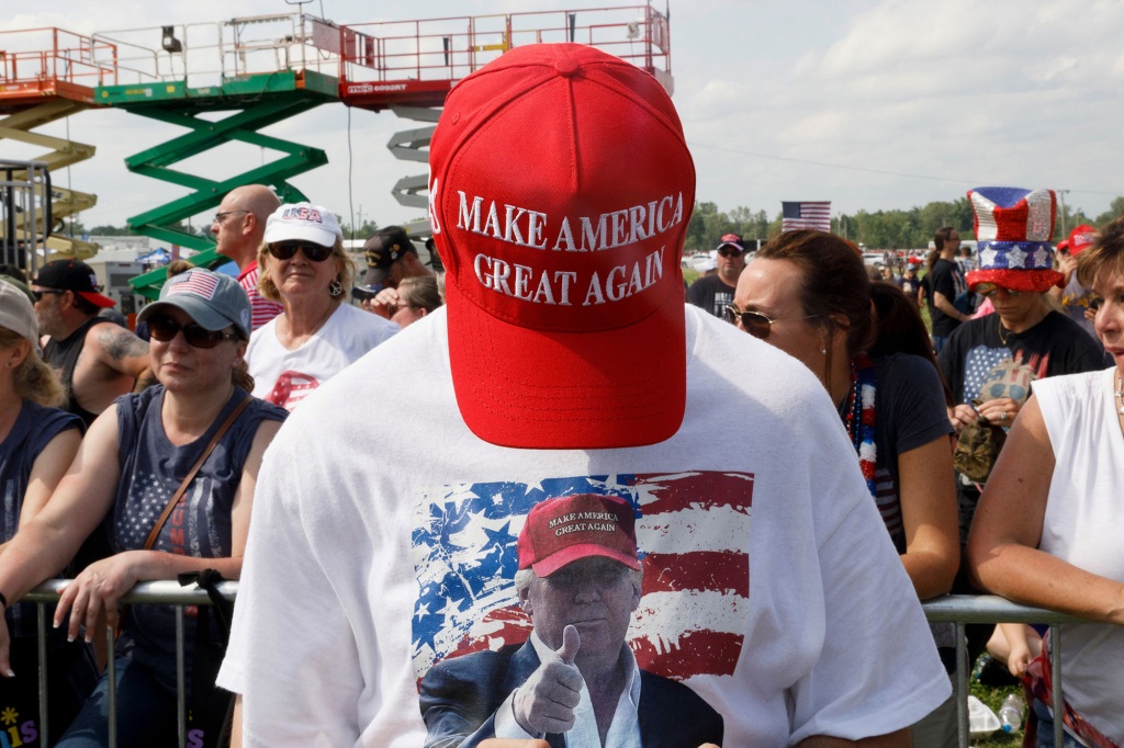 A Trump supporter shows his MAGA hat during a Trump campaign-style rally.