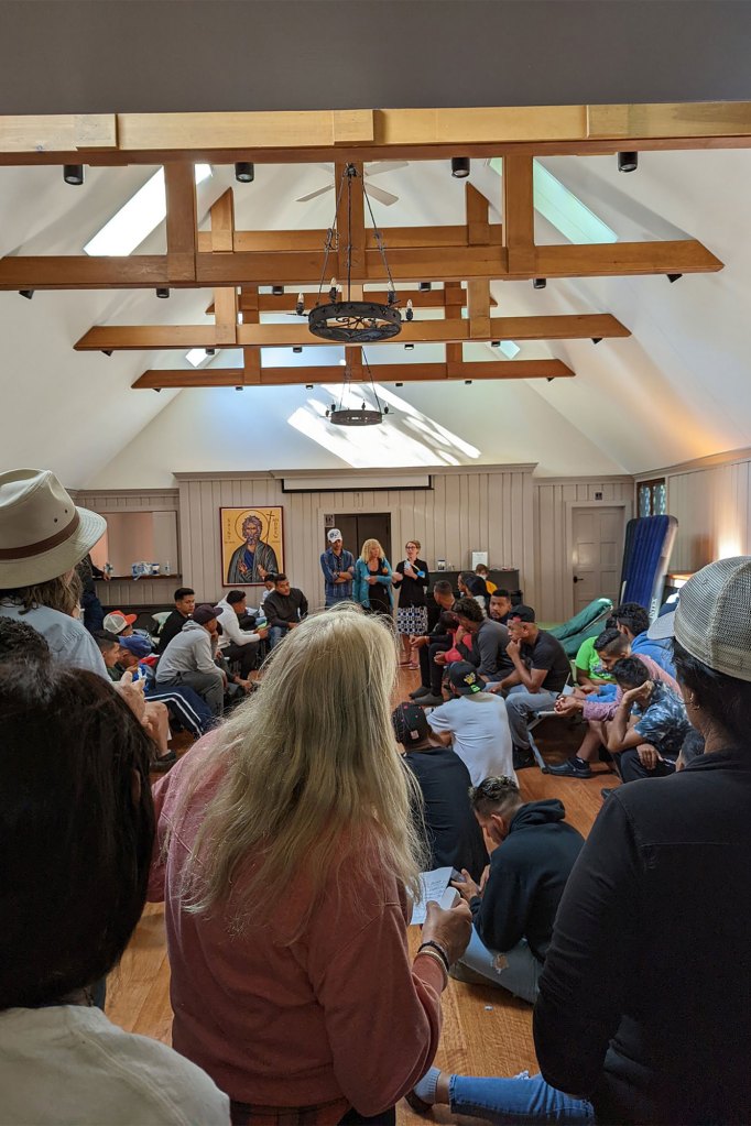 Migrants gathered in a room in Martha's Vineyard.