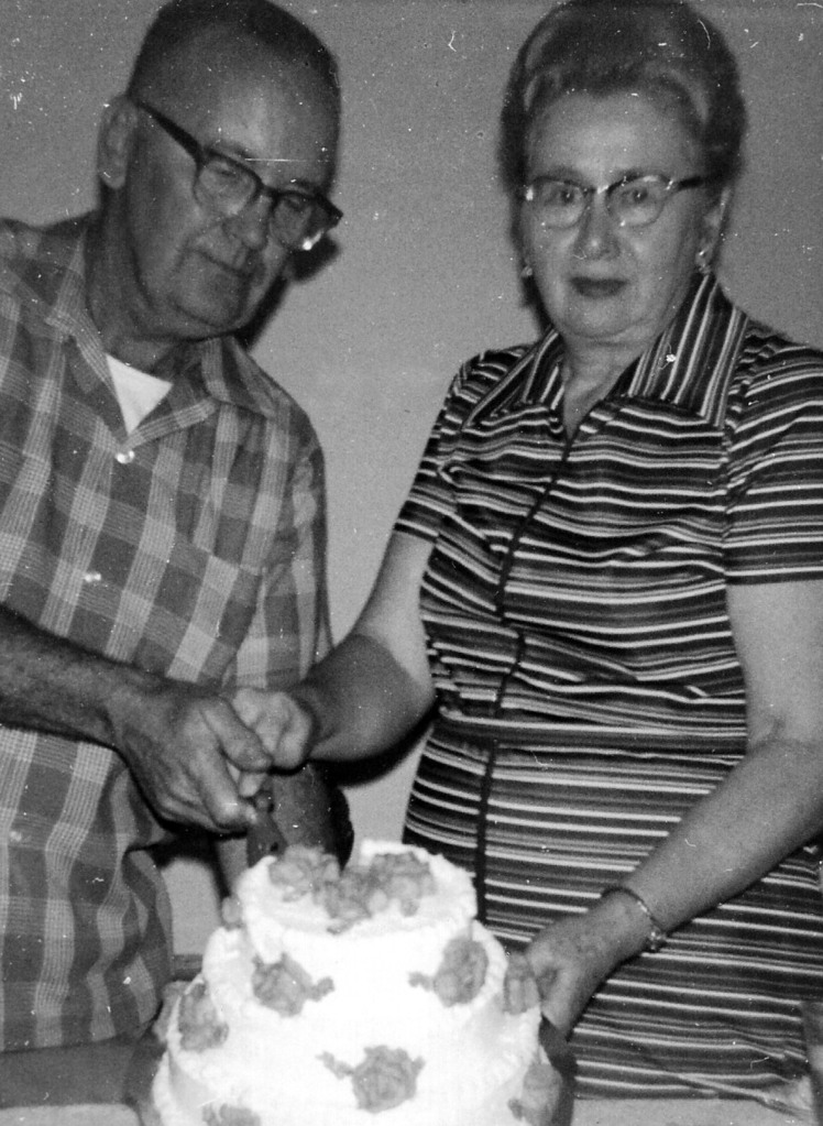 James Hall and his wife cut a cake.