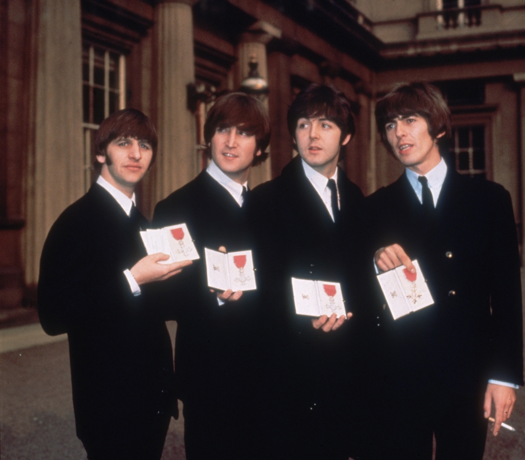 (left to right) Ringo Starr, John Lennon, Paul McCartney and George Harrison receive their MBEs (Member of the Order of the British Empire) from Queen Elizabeth II on October 26, 1965. 