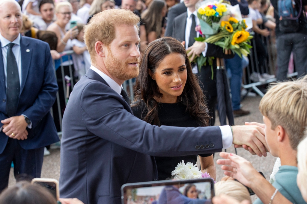 Prince Harry and Meghan Markle greet spectators outside of Windsor Castle.