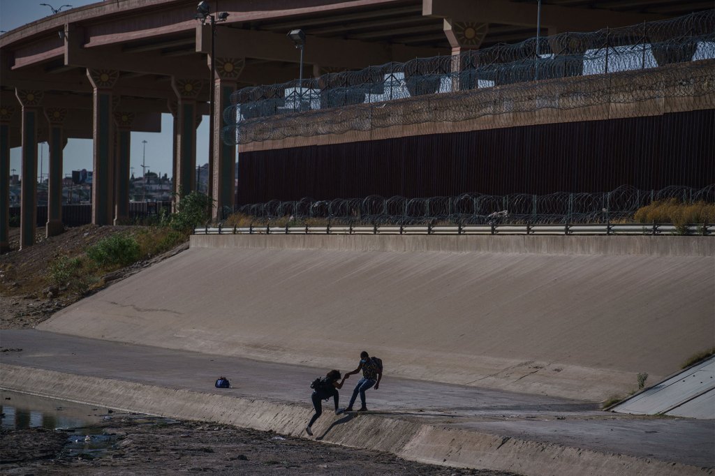 Migrants cross the border to El Paso, Texas, as seen from Ciudad Juarez