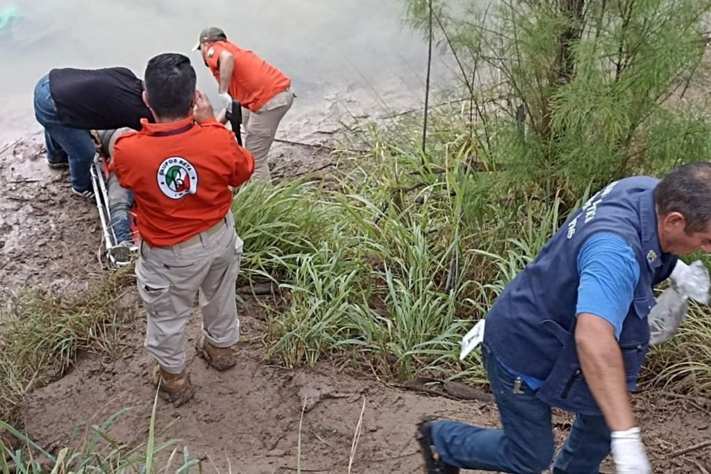 Members of the Mexican immigrant agency Grupo Beta participate in the rescue of a migrant who was found in a river in Reynosa, Mexico