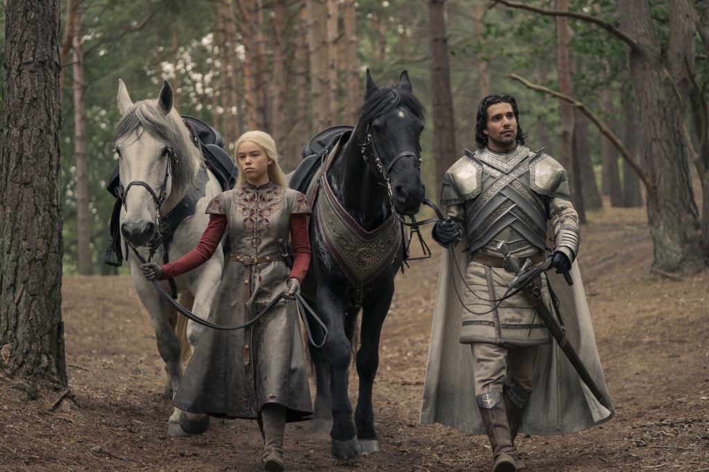 Rhaenyra (Milly Alcock) with Criston Cole (Fabien Frankel) during happier times walking with a horse between them in a forest on "House of the Dragon." 