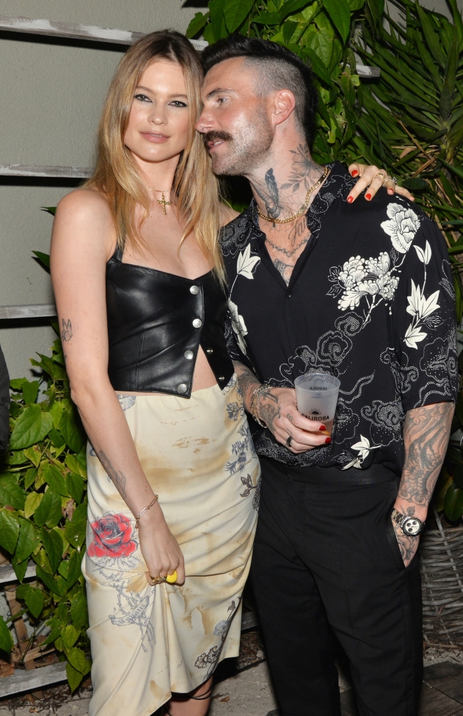 Behati Prinsloo and Adam Levine at the Calirosa Tequila Sunset Happy Hour at South Beach Wine & Food Festival on February 24th, 2022 in Miami Beach, Florida. 